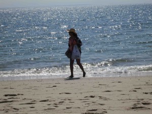 A beachgoer walks along the shore in Truro, MA, January 17, 2015