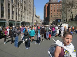 A runner in a warming blanket and scores of others who came out to watch the 2016 marathon