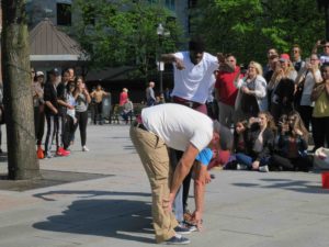 You Already Know acrobats jump over a line of volunteers during their act